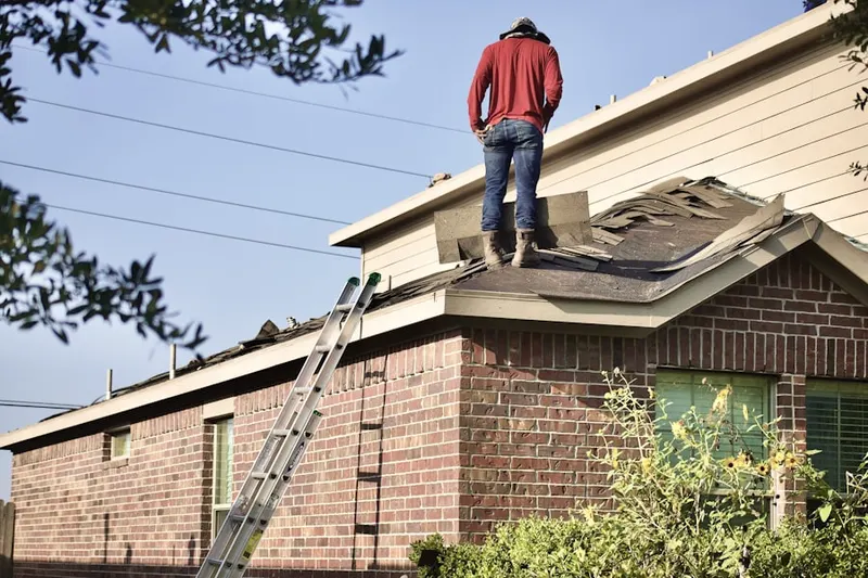 Professional roofer working on a residential roof in Dunwoody